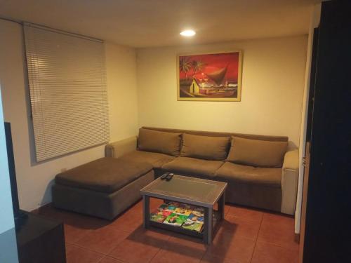 ein Wohnzimmer mit einem Sofa und einem Tisch in der Unterkunft CASA COMPLETA 2 PLANTAS CON EXTRAORDINARIA VISTA AL CANAL BEAGLE CENTRICA 4pax in Ushuaia