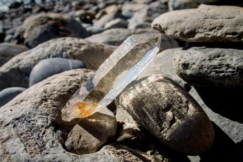 a piece of glass sitting on some rocks at Ponci’s Gate to Gaia Holistic Center in Bocas del Toro