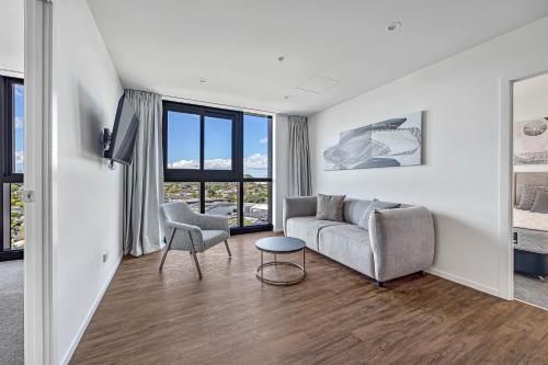 a living room with a couch and a chair at Central Park Residence in Auckland