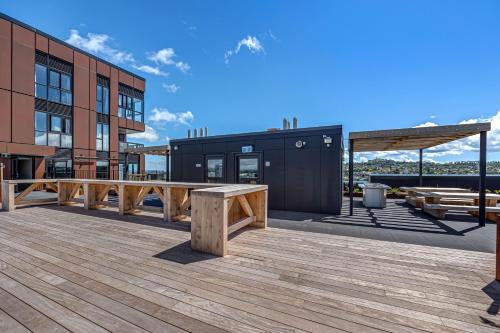 a wooden deck with a bench on a building at Central Park Residence in Auckland