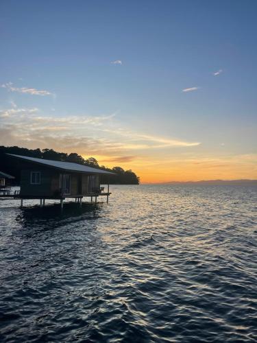 a house on a dock on a body of water at Ponci’s Gate to Gaia Holistic Center in Bocas del Toro