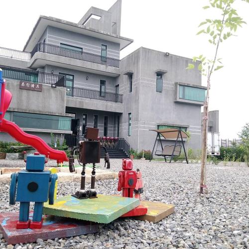 a playground with play equipment in front of a building at Muzhe-Fascinating in Dongshan