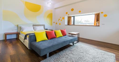 a bedroom with a bed with colorful pillows at Muzhe-Fascinating in Dongshan