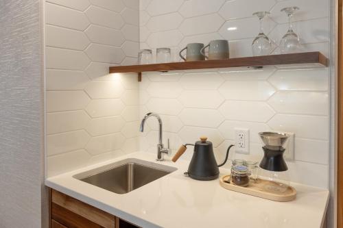 a kitchen counter with a sink and a mixer at Hotel Canoe and Suites in Banff