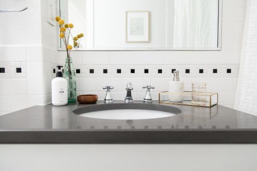 a bathroom counter with a sink and a mirror at The Suites at the Touraine No 107 in Philadelphia