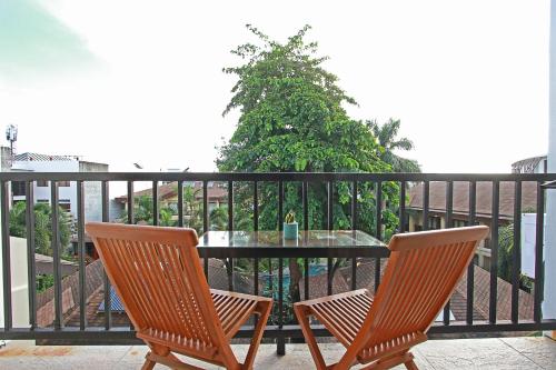 two chairs and a table on a balcony at Aloha Boracay Hotel in Boracay
