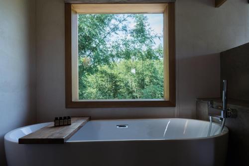 a large bath tub in a bathroom with a window at South of Shushan - On the left bank in Changning