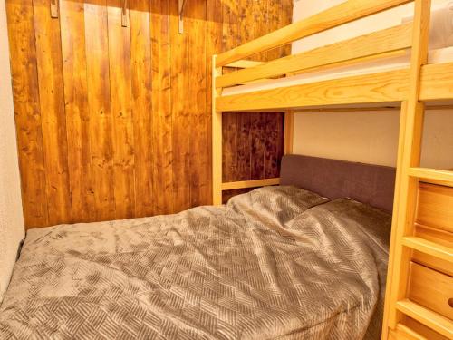 a bedroom with a bunk bed and wooden walls at Studio Notre-Dame-de-Bellecombe, 2 pièces, 5 personnes - FR-1-505-102 in Notre-Dame-de-Bellecombe