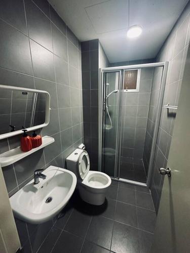 a bathroom with a shower and a toilet and a sink at Family friendly apartment @Southville City in Kampong Tangkas