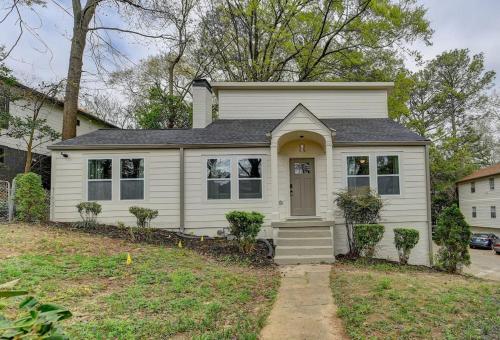 a small white house with a door in a yard at New Home in MidTown- Sleeps 11 For Rent in Atlanta in Atlanta