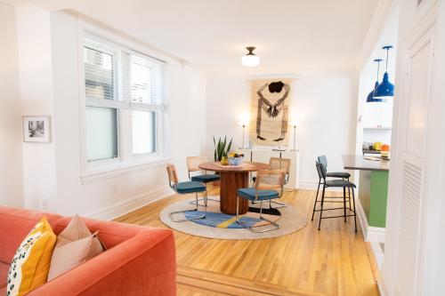 a living room with a table and chairs at The Suites at the Touraine No 109 in Philadelphia