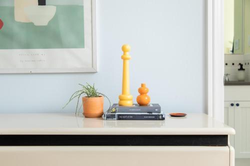 a table with a lamp and a plant on it at The Suites at the Touraine No 109 in Philadelphia