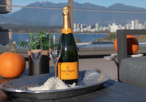 a bottle of champagne on a table with two glasses at Historic Townhouse in Kitsilano in Vancouver