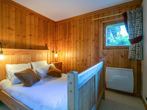 a bedroom with a bed with wooden walls and a window at Appartement Val-d'Isère, 6 pièces, 10 personnes - FR-1-694-336 in Val-d'Isère