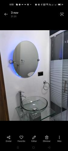 a bathroom with a glass sink and a mirror at Alojamientos Barrancas in San Antonio