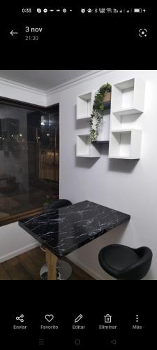 a black marble table and chairs in a room at Alojamientos Barrancas in San Antonio