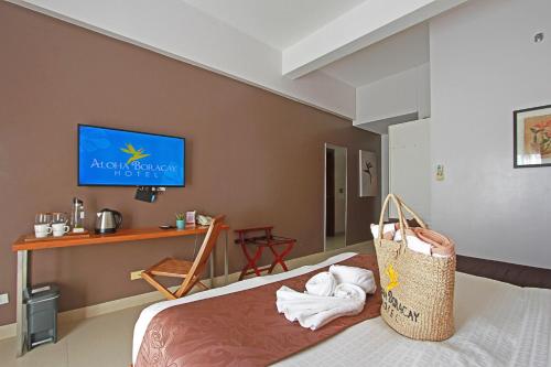 a hotel room with a bed with a bag on it at Aloha Boracay Hotel in Boracay