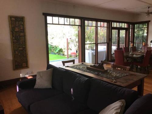 a living room with a couch and a table at Contemporary & Elegant 1920's Period House by My Lodgingfy International in Mentone