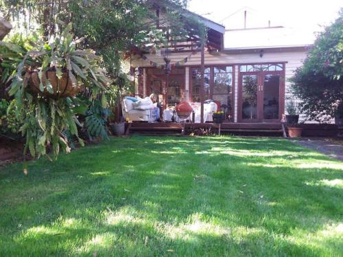 a yard with green grass and a house at Contemporary & Elegant 1920's Period House by My Lodgingfy International in Mentone