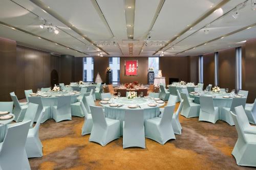a conference room with white tables and white chairs at Le Meridien Taipei in Taipei