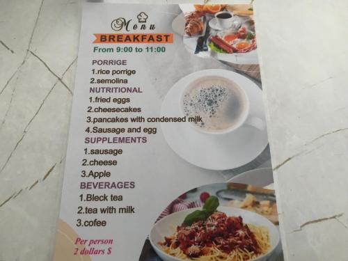 a menu for a restaurant with food on it at Cottage town D&N in Karakol