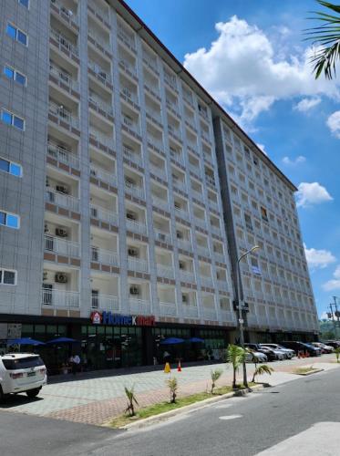 a large building with cars parked in front of it at Private Room in M Stay Hotel - Inside Clark, near Midori, Swissotel, and Marriott in Dolores