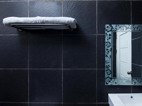 uma casa de banho com um espelho e uma toalha em RAP Hotel Balige em Balige