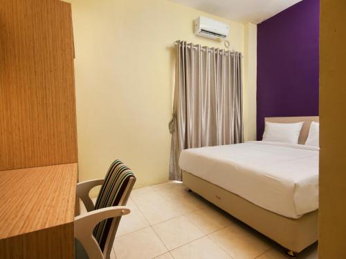 Кровать или кровати в номере RAP Hotel Balige