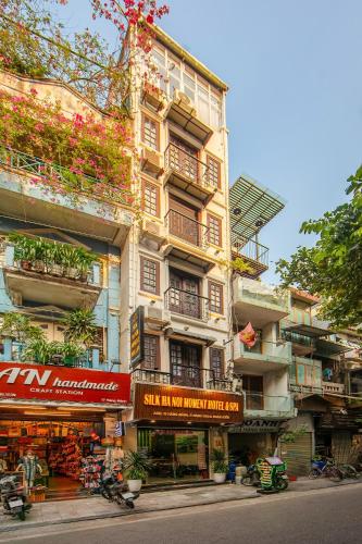 a tall building with plants on the side of it at Silk Hanoi Moment Hotel & Spa - Hanoi Old Quarter in Hanoi