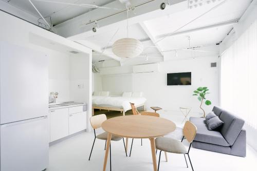 a kitchen and living room with a table and a couch at Asakusa 1976 in Tokyo