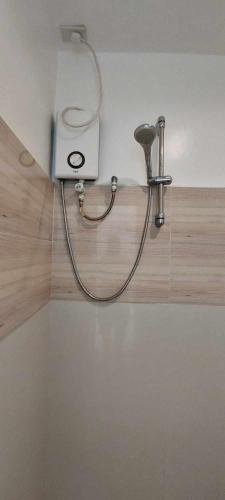 a blow dryer on the wall of a bathroom at Casa Santuaria in Itaytay