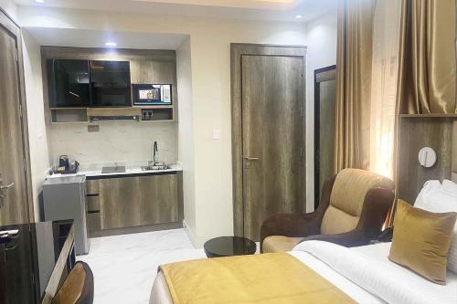 a hotel room with a bed and a kitchen at Castle Estate Apartments 3 in Abuja