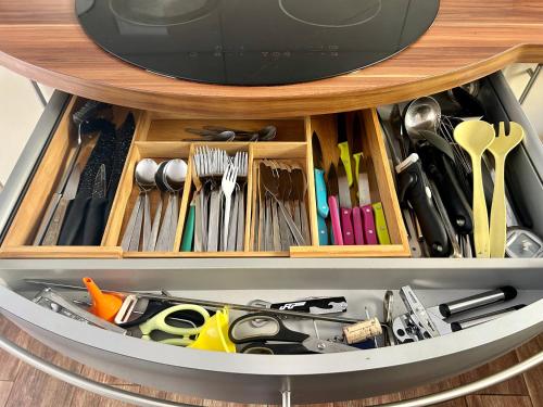 a drawer filled with lots of different types of tools at Maison vue mer chaleureuse et confortable in Petite Île