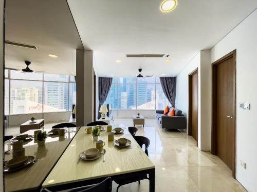 a dining room and living room with a table and chairs at Vortex suites klcc by Hafizah suites in Kuala Lumpur