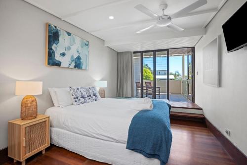a bedroom with a bed and a ceiling fan at Bronze in Lennox Head