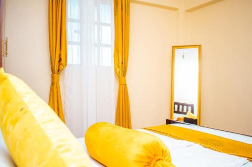 een slaapkamer met 2 bedden en een spiegel bij Cozy apartment kisii in Kisii