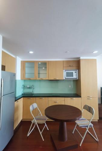 a kitchen with a table and chairs and a refrigerator at River House Near The Peoples Square And The Bund in Shanghai
