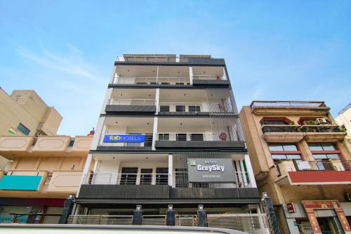 a tall building with a blue sign on it at FabHotel Sky Suites Karkardooma in New Delhi