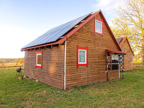 a small house with a solar roof on a field at Nr3 - W POLU DOBREJ ENERGII 