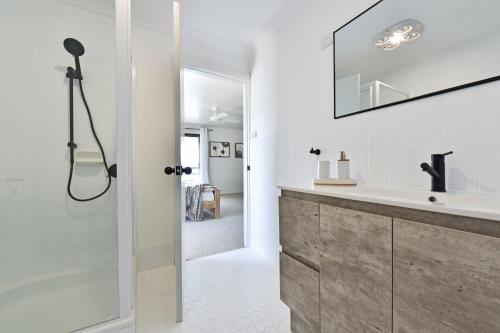 a bathroom with a shower and a sink at New Property Silverwater Serenity Shores Absolute Waterfront On The Lake in Bonnells Bay