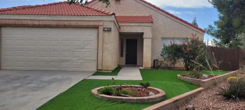 a house with a yard with a garage at Be Our Guest-Shared Home Tampa in Palmdale