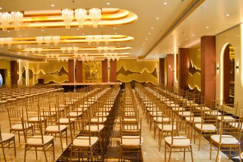 a row of chairs in a banquet hall at Tulip Inn Shravasti in Katra