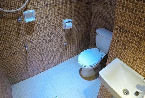 a bathroom with a toilet and a sink at RedDoorz Plus @ Taj Hotel Tuguegarao in Tuguegarao City