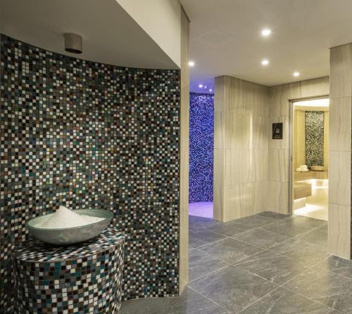 a bathroom with a bowl on a table and a shower at DAMAC Maison Aykon City Dubai in Dubai