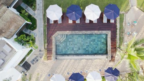 an overhead view of a swimming pool with umbrellas at Seapoint Boutique Hotel in Pointe aux Canonniers