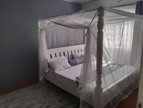a bed with a canopy in a room at Casa Nostra funyula in Nangina