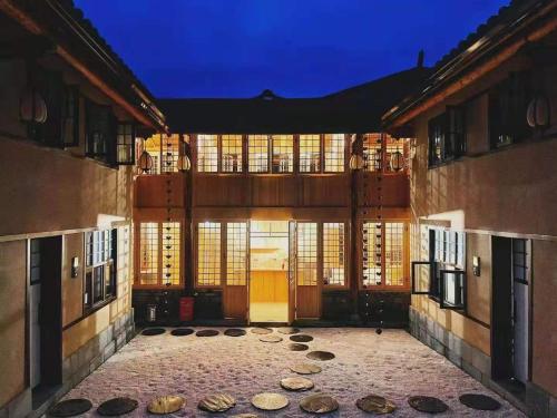 een gebouw met een binnenplaats met ramen en een deur bij Wudang Mountain Manju Manor in Wudangshan