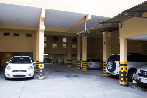 a group of cars parked in a parking lot at Rede Andrade Mercado Hotel in Curitiba