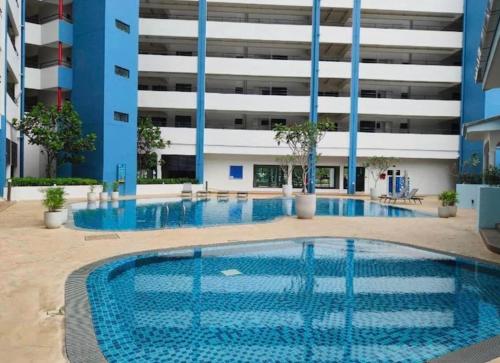 a swimming pool in the middle of a building at Mutiara Melaka Beach Resort by Minso in Tangga Batu