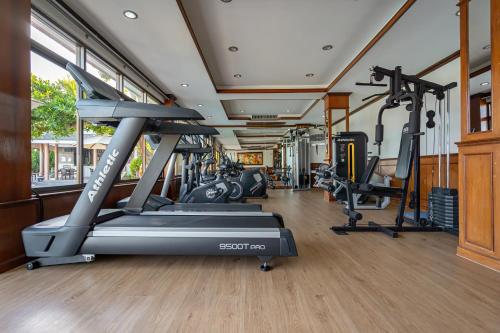a gym with treadmills and elliptical machines at Orchidacea Resort - Kata Beach in Kata Beach